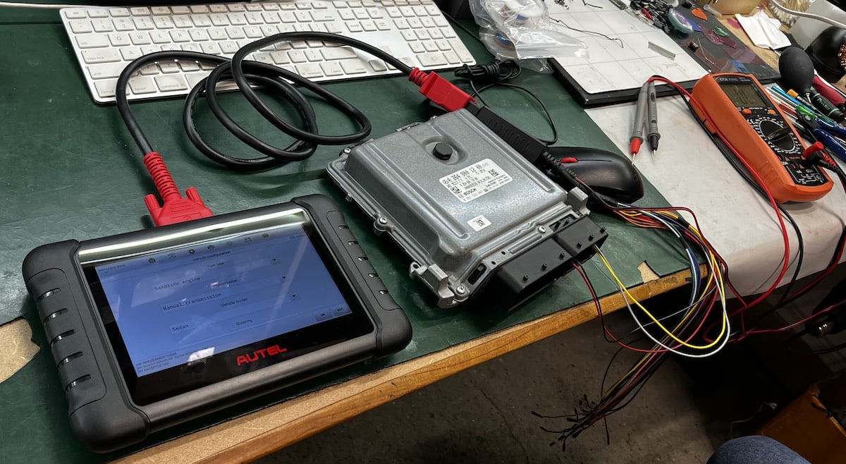 ECU module connected for bench testing at Device Repair Guy