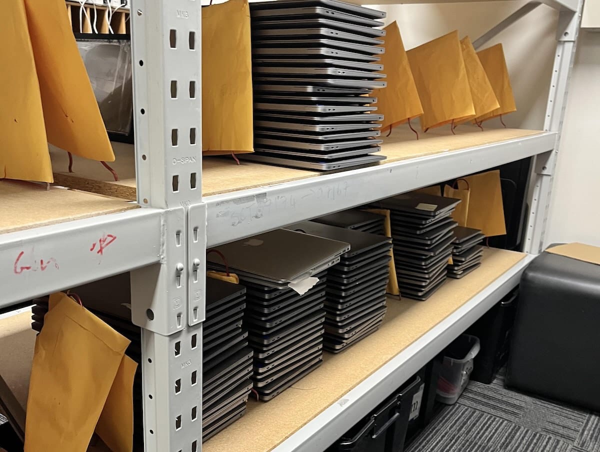 Stack of Apple MacBooks prepared for business buyback and resale in New Zealand